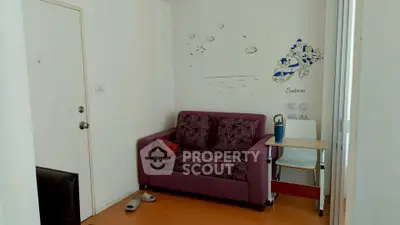 Cozy living room with purple sofa and wall art in modern apartment