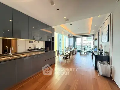 Luxurious open-plan kitchen and living area with modern design and city view.