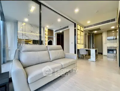 Modern open-plan living room with sleek kitchen and stylish decor