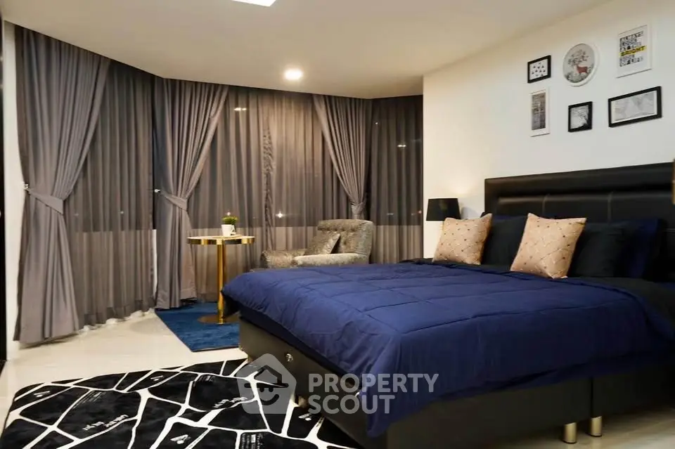 Luxurious bedroom with modern decor and large windows in a stylish apartment.
