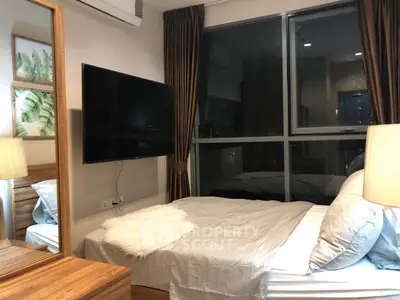 Cozy bedroom with large window and modern decor in urban apartment