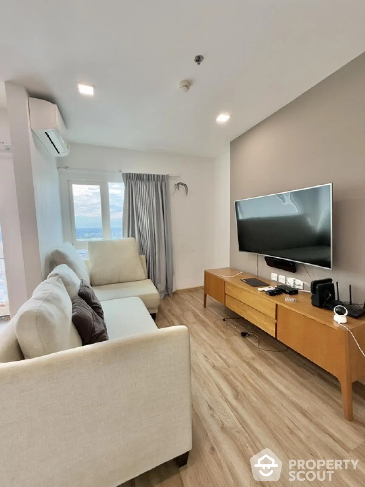 Modern living room with sleek design and large window offering a stunning view.