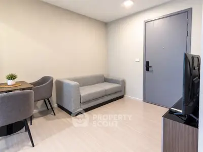 Modern living room with cozy gray sofa and dining area in stylish apartment.