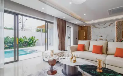 Luxurious living room with pool view, elegant decor, and modern furniture in a stylish home.