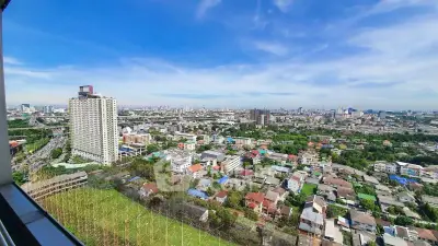 Stunning panoramic city view from high-rise building, showcasing urban landscape and skyline under clear blue sky.