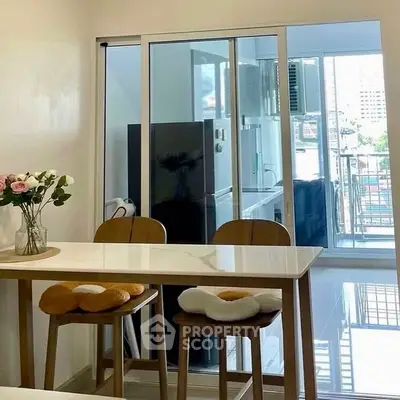Modern dining area with balcony view and elegant decor