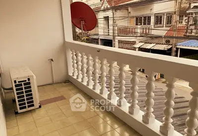 Charming balcony with street view and satellite dish, perfect for urban living.