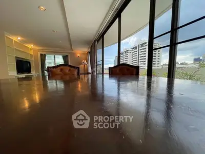 Spacious living room with large windows and city view