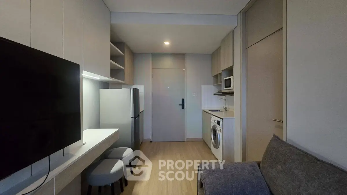 Modern compact apartment with sleek kitchen and cozy living area