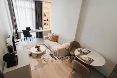 Modern living room with stylish decor and natural light, featuring a cozy sofa and elegant dining area.