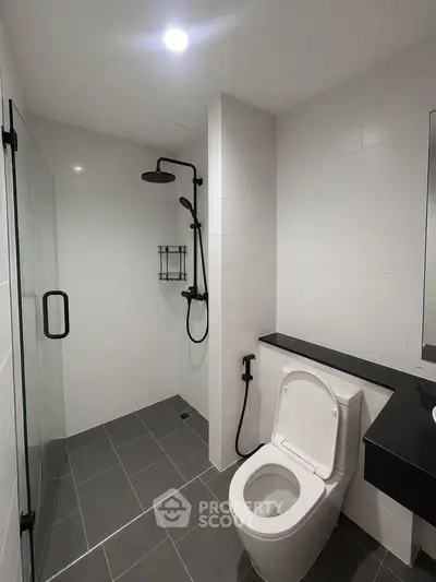 Modern bathroom with sleek shower and toilet in contemporary apartment