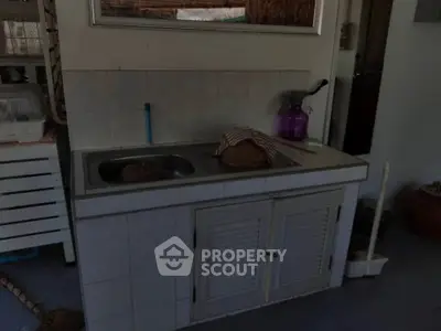 Compact kitchen area with sink and storage, ideal for small spaces.