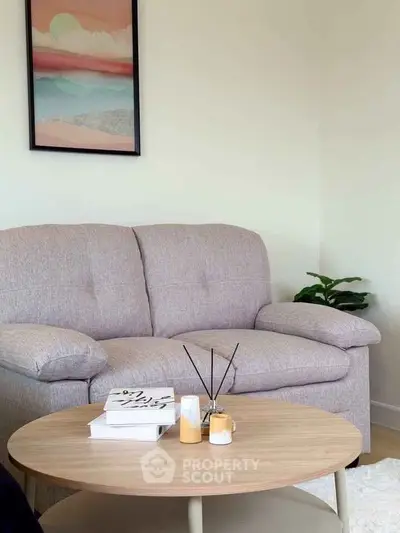 Cozy living room with plush sofa and stylish coffee table, perfect for relaxation.