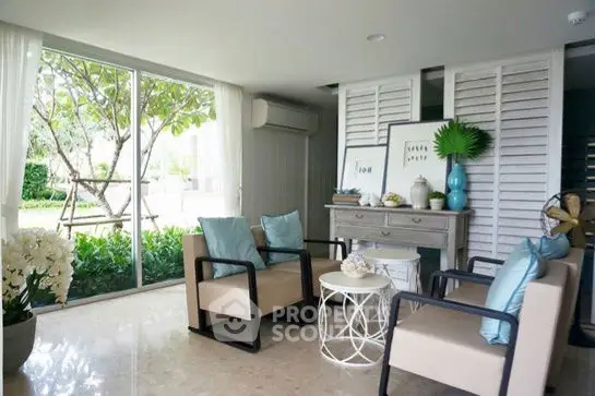 Chic living room with modern decor and garden view, featuring elegant furniture and natural light.