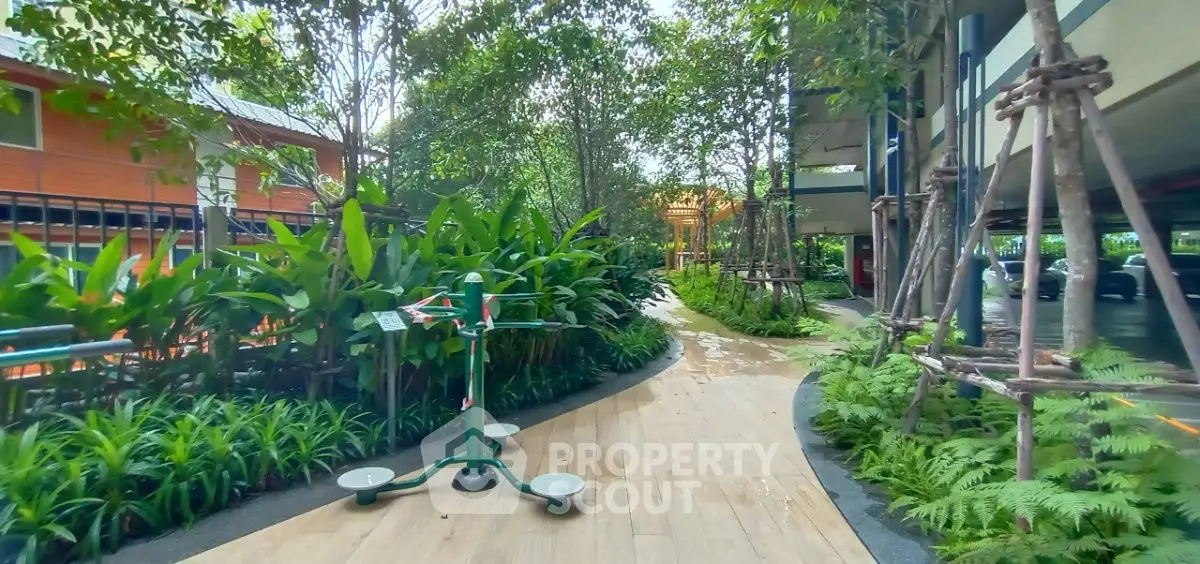 Lush garden pathway with fitness equipment in modern residential complex