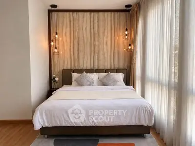 Luxurious bedroom with elegant lighting and large windows for natural light.