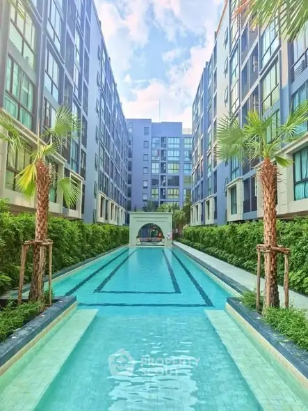 Luxurious apartment complex with stunning outdoor pool and modern architecture.