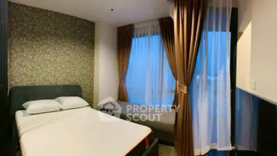 Cozy bedroom with modern decor and large windows offering city views.