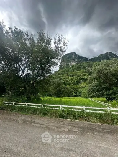 Scenic view of lush greenery and mountains ideal for real estate development.