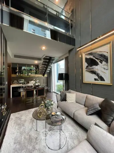 Luxurious multi-level living space with high ceilings, modern furnishings, and a sleek kitchen, perfect for upscale urban living.