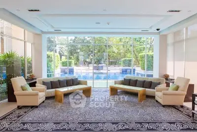 Luxurious living room with pool view and elegant furniture in modern home.