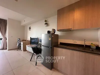 Modern studio apartment with sleek kitchen and cozy living area