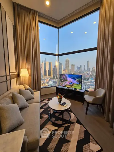 Luxurious living room with stunning city view, elegant decor, and cozy seating area in high-rise apartment.