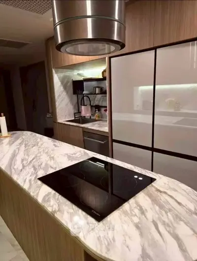 Modern kitchen with marble countertops and sleek appliances in a stylish home.