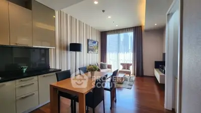 Modern open-layout living room with dining area and city view, featuring sleek furniture and wooden flooring.