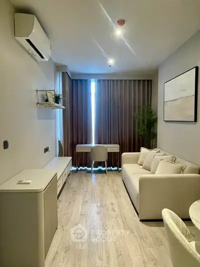 Modern living room with stylish decor and natural light, featuring a cozy sofa and elegant furnishings.