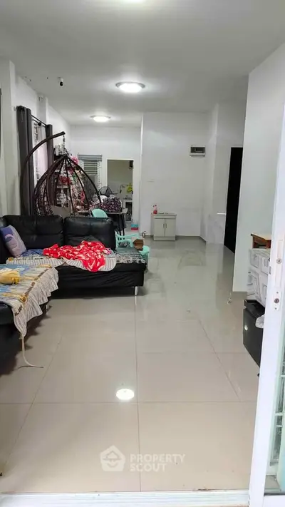 Spacious living room with modern furniture and glossy tiled flooring