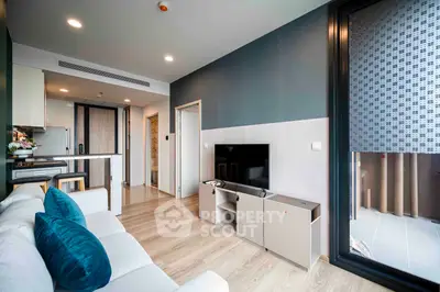 Modern living room with sleek design and balcony access in a contemporary apartment.