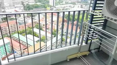 High-rise balcony with stunning city view and modern railing, perfect for urban living.
