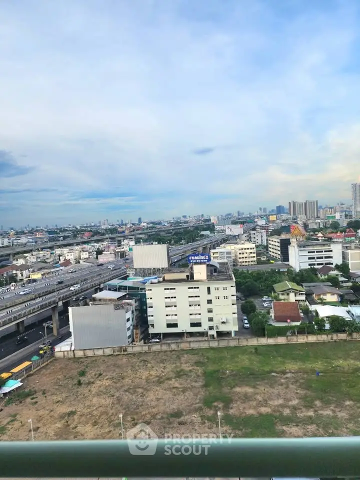 Stunning cityscape view from high-rise building balcony showcasing urban skyline and vibrant city life.