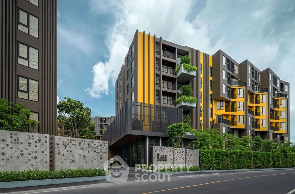 Modern apartment building with unique architectural design and lush greenery