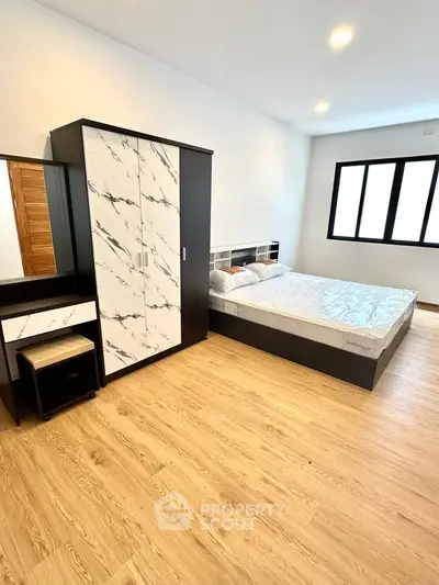 Spacious modern bedroom with stylish furniture and natural light