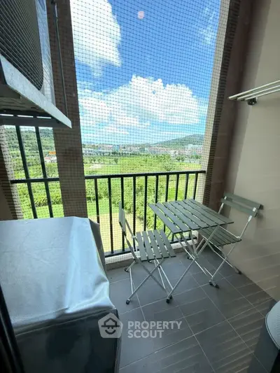 Charming balcony with scenic view, perfect for relaxation and outdoor dining.