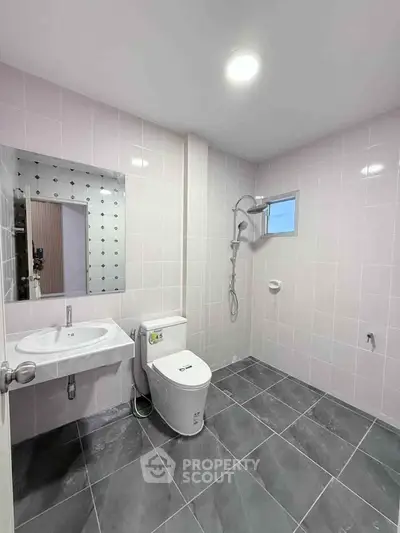 Modern bathroom with sleek fixtures and spacious layout in contemporary home.