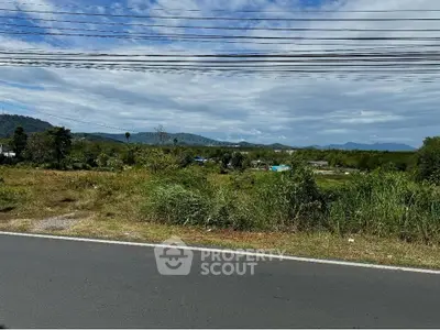 Scenic view of open land with mountains in the background, ideal for development opportunities.