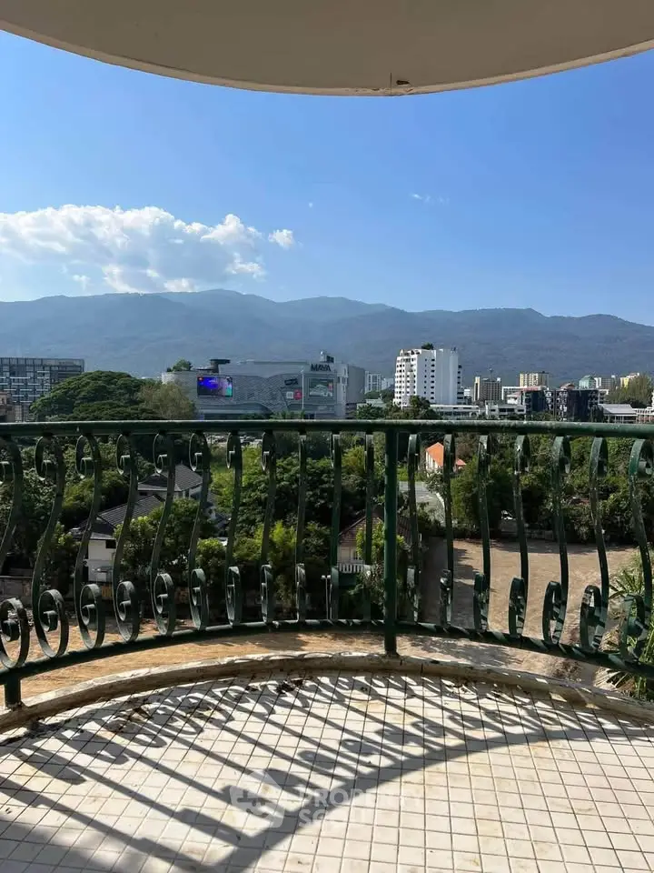 Stunning balcony view overlooking cityscape and mountains, perfect for relaxation.
