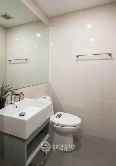 Modern bathroom with sleek fixtures and large mirror