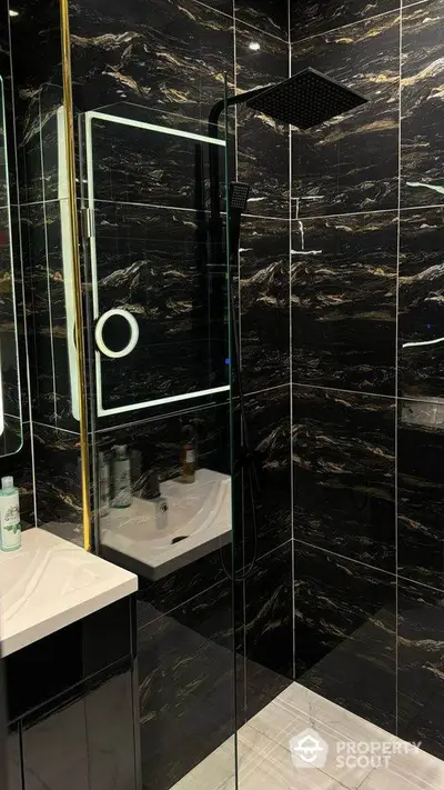 Luxurious black marble bathroom with modern shower and sleek design