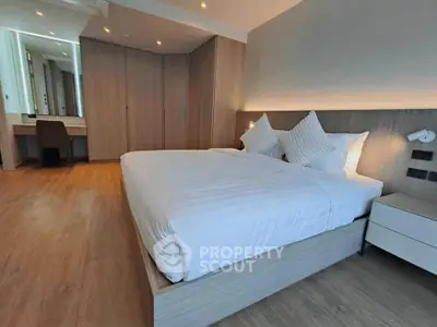 Spacious modern bedroom with elegant wooden flooring and stylish decor