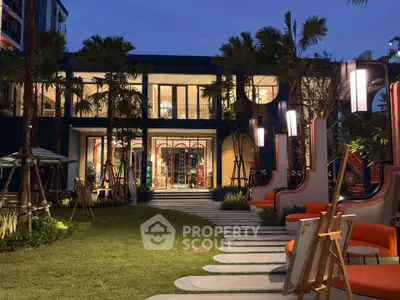 Luxurious modern building exterior with elegant garden and stylish outdoor seating at dusk.