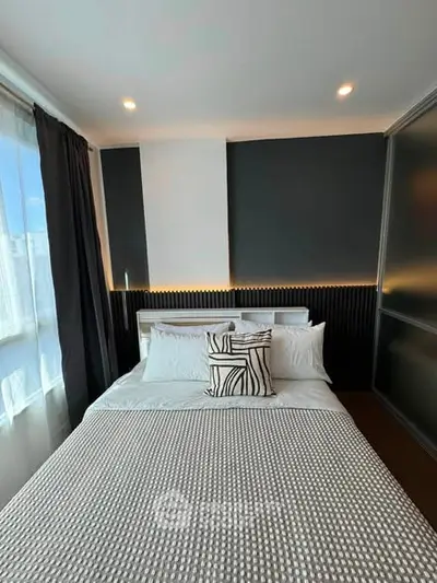 Modern bedroom with stylish decor and ample natural light in a contemporary apartment.