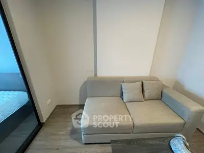 Modern living room with cozy gray sofa and wooden flooring