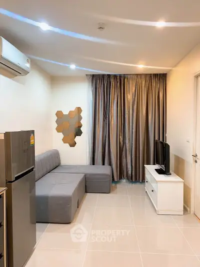 Modern living room with sleek design, featuring a gray sofa, wall-mounted TV, and stylish decor.