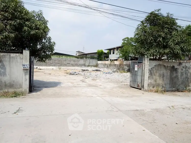 Vacant land plot with gated entrance, ideal for development opportunities.