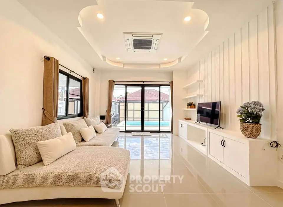 Spacious modern living room with pool view and elegant decor