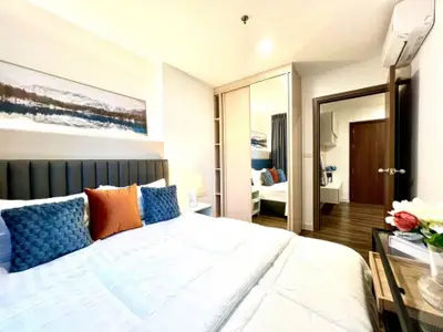 Modern bedroom with stylish decor and ample natural light